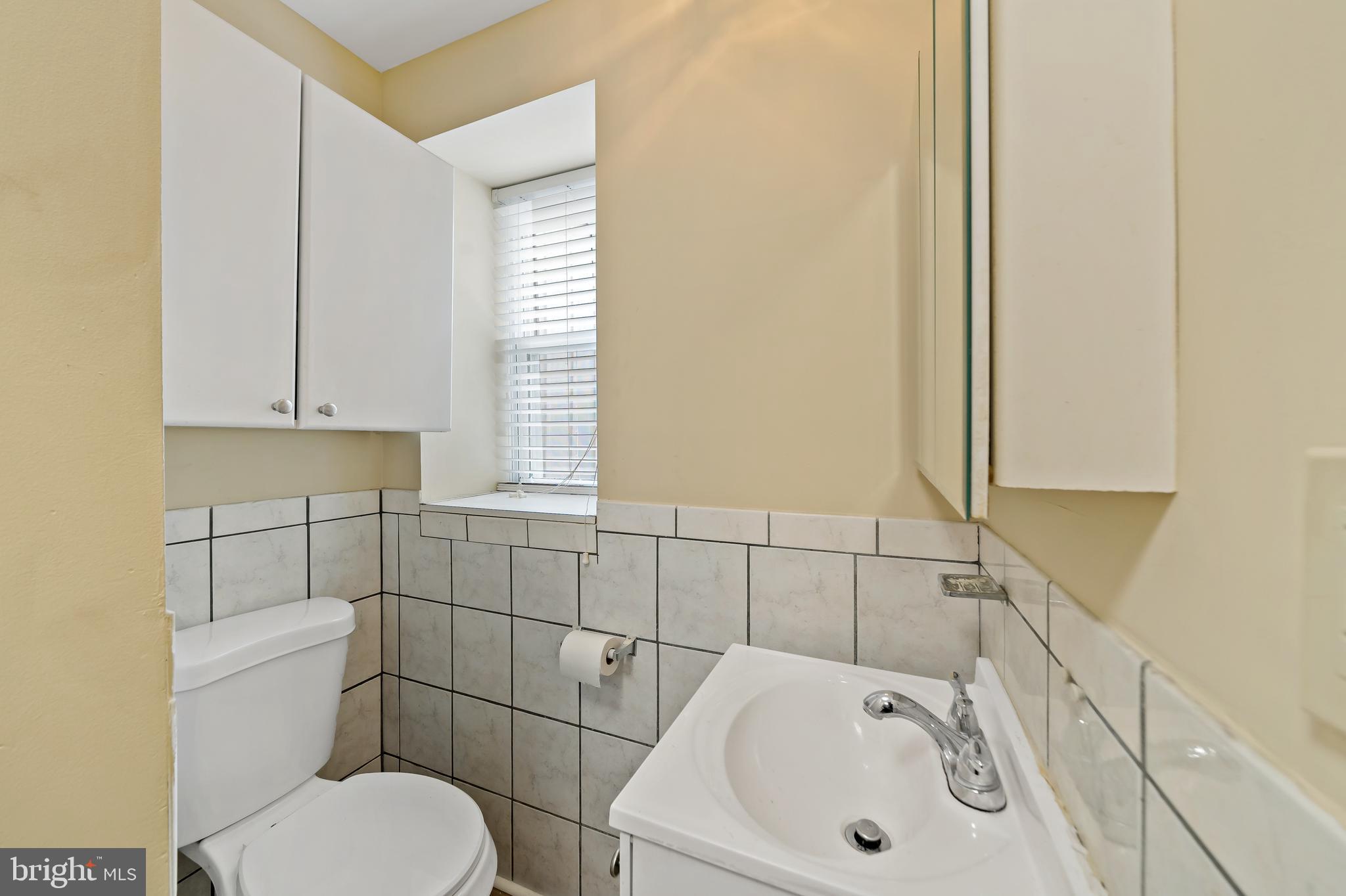 2537 South Broad Street, Unit 2 Philadelphia, PA 19148 - Photo 12 of 18 a bathroom with a sink a toilet and mirror