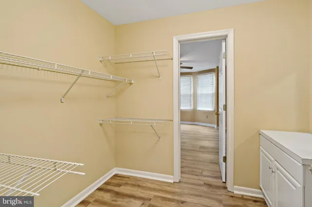 a view of walk in closet with empty racks