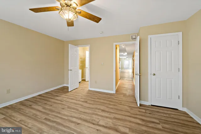 a view of an empty room with wooden floor