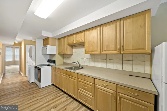 a kitchen with a sink window and cabinets
