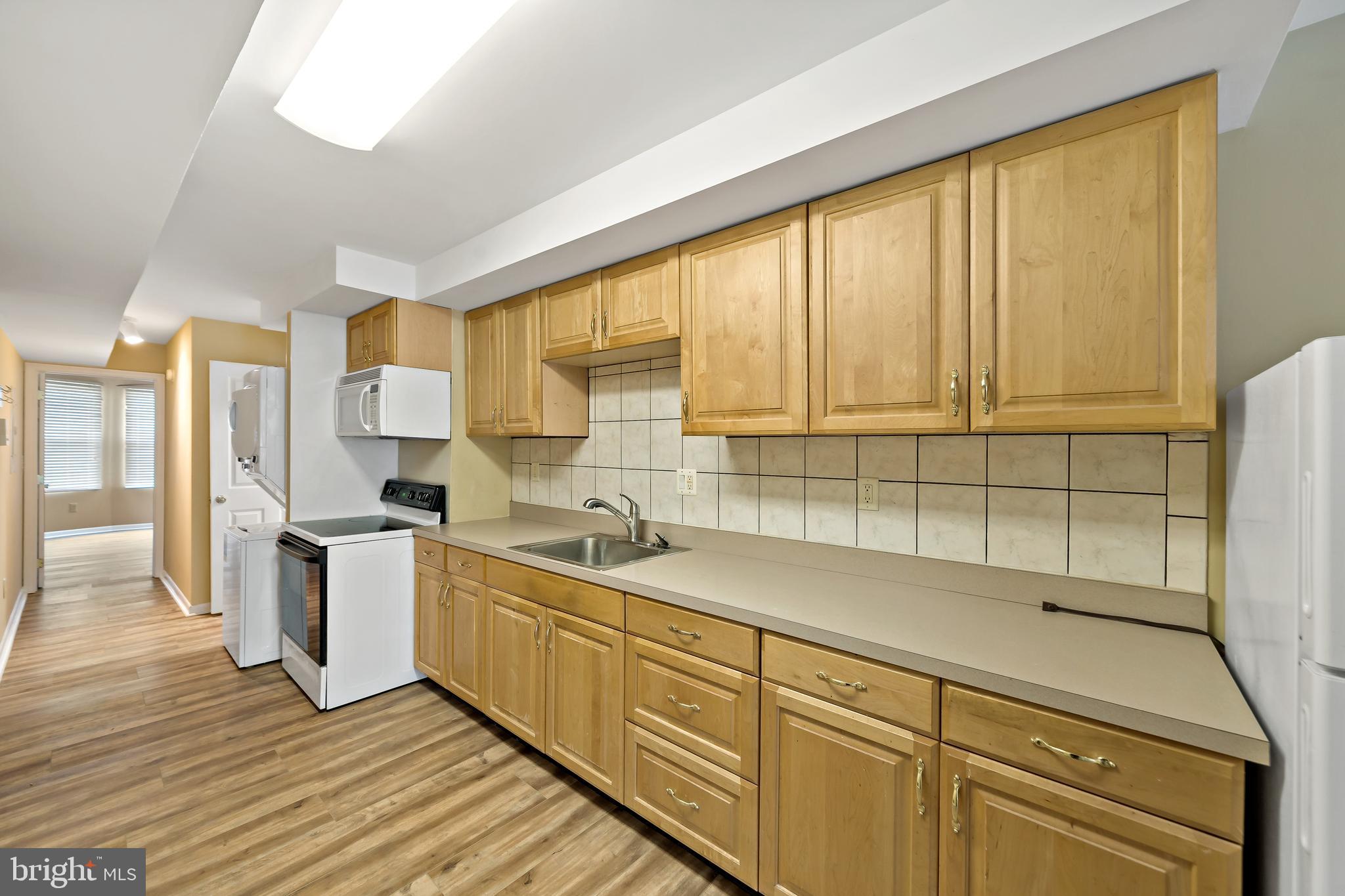 2537 South Broad Street, Unit 2 Philadelphia, PA 19148 - Photo 5 of 18 a kitchen with a sink window and cabinets