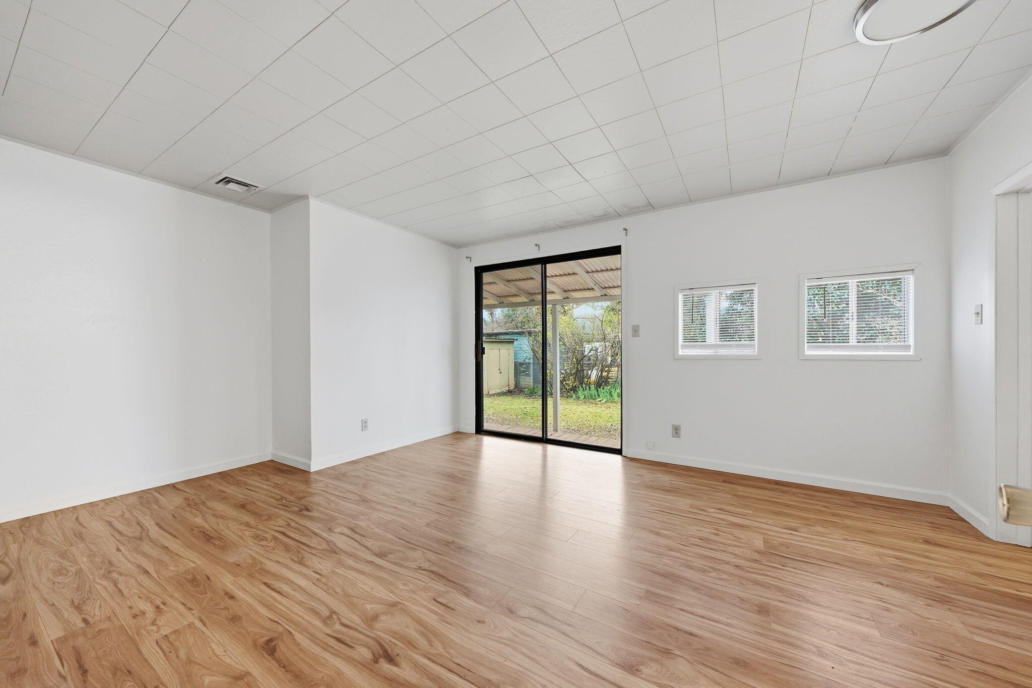 1717 Deer Creek Road Shasta Lake, CA 96019 - Photo 16 of 54 a view of an empty room with wooden floor and a window