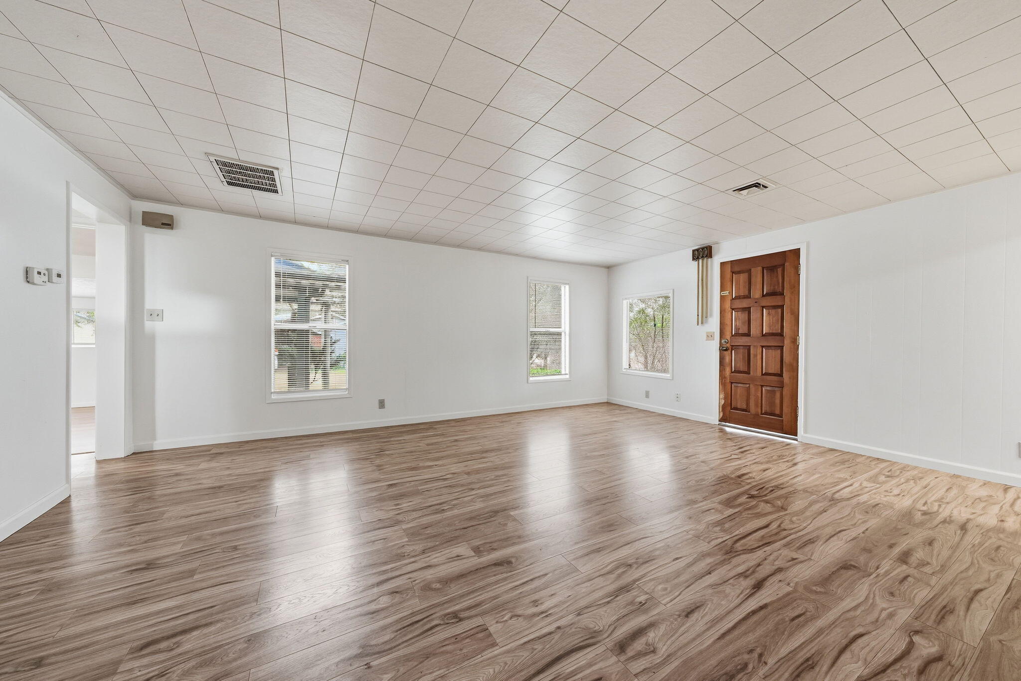 1717 Deer Creek Road Shasta Lake, CA 96019 - Photo 5 of 54 a view of an empty room with wooden floor and a window
