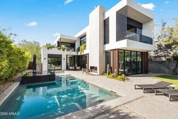 a view of a house with swimming pool and sitting area
