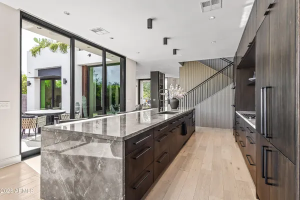 a large kitchen with stainless steel appliances double vanity and a large window