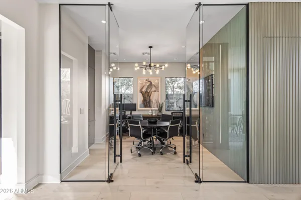 a living room with furniture and a floor to ceiling window
