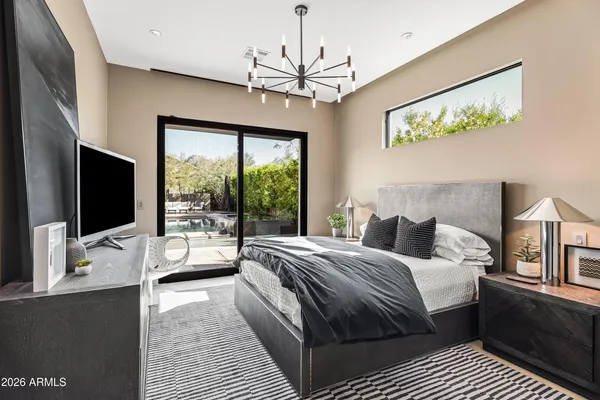 a bedroom with bed and a flat screen tv