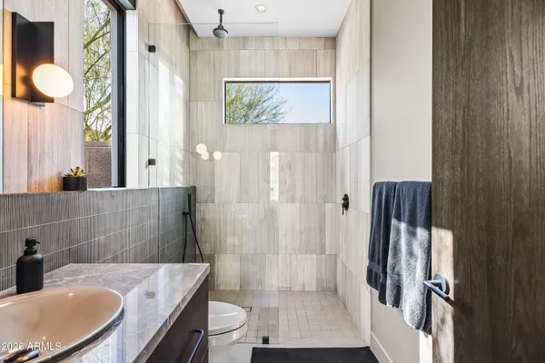 a bedroom with furniture and large windows