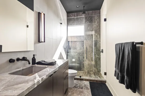 a view of swimming pool with seating space and trees in the background