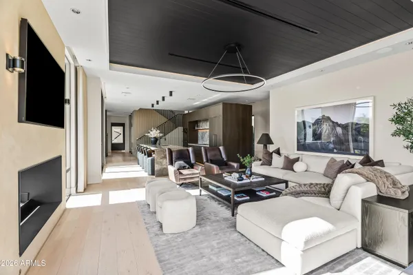 a living room with furniture fireplace and flat screen tv