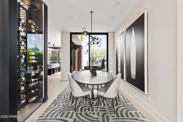 a dining room with furniture a chandelier and window