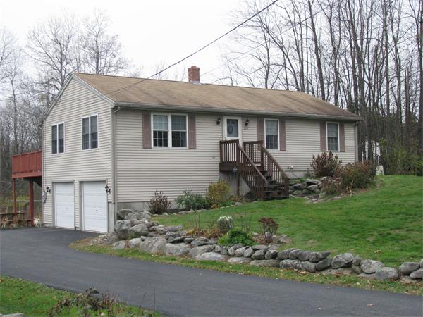 157 Hardwick Road Barre, MA 01005 - Photo 1 of 8 a front view of a house with a garden and plants