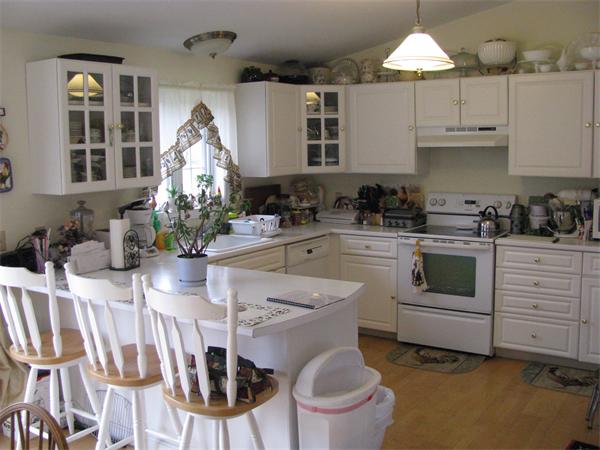 157 Hardwick Road Barre, MA 01005 - Photo 4 of 8 a kitchen with white cabinets and white appliances