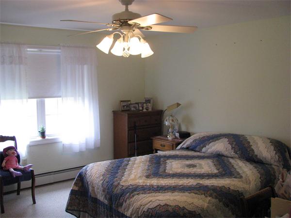 157 Hardwick Road Barre, MA 01005 - Photo 5 of 8 a bedroom with a bed and a chandelier