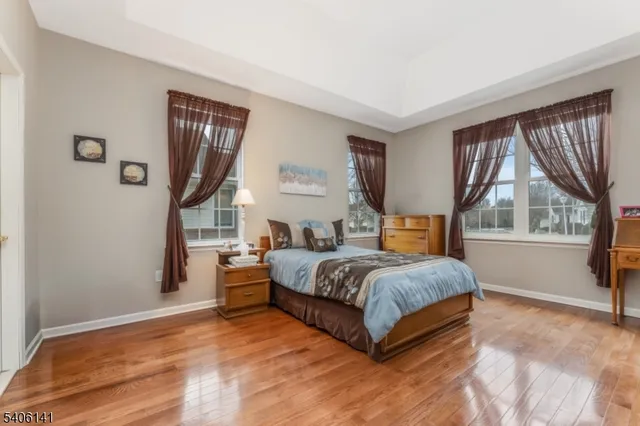 a spacious bedroom with a bed and a large window