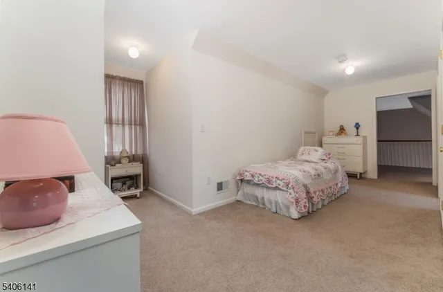 a bedroom with a bed and a chair