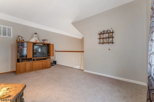 an empty room with windows and cabinet