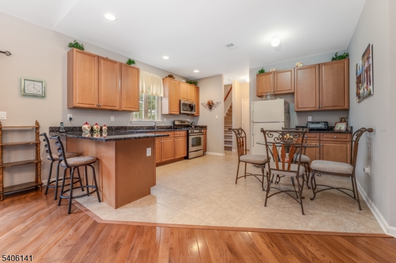 107 Samson Drive Flemington, NJ 08822 - Photo 8 of 29 a kitchen with stainless steel appliances granite countertop wooden cabinets a table and chairs