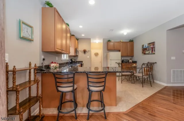 a kitchen with a table chairs stove and cabinets