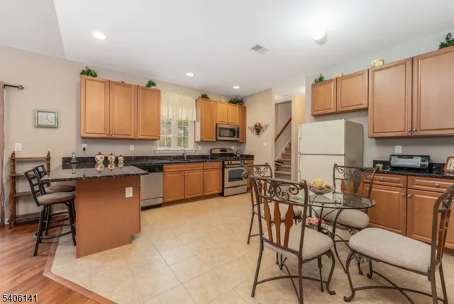 a kitchen with stainless steel appliances granite countertop counter space a sink and cabinets