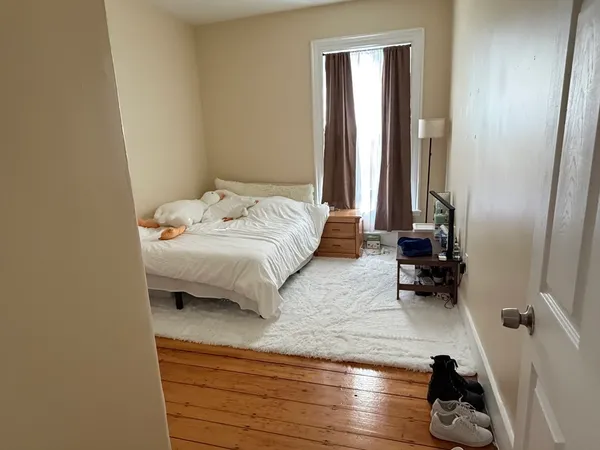 a bedroom with a bed and a window