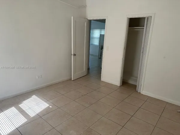 a kitchen with a stove top oven and cabinets