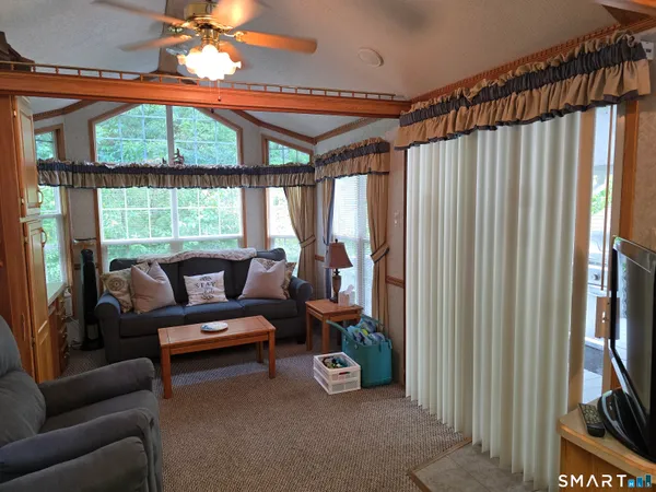 a view of a livingroom with furniture and a window