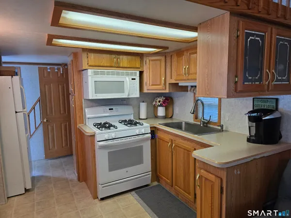 a kitchen with a stove and a refrigerator