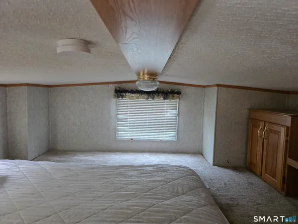 a bedroom with furniture and window
