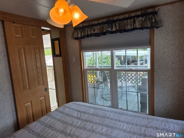 a bedroom with window and a bed