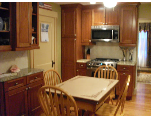 12 Brae Burn Road Milton, MA 02186 - Photo 3 of 18 a kitchen with stainless steel appliances a sink a microwave cabinets and wooden floor