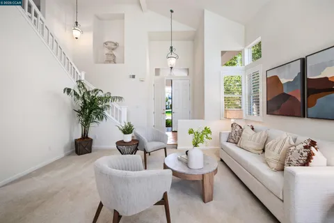 a living room with furniture and a potted plant