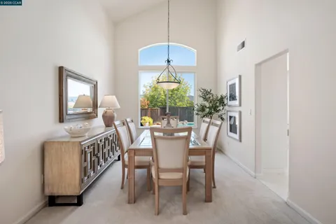 a dining room with furniture window and wooden floor
