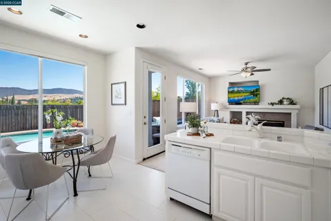 a room with a sink a window and chairs