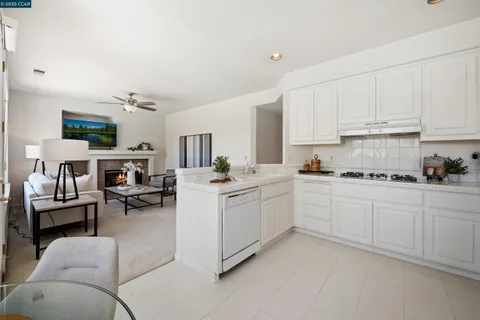 a kitchen with cabinets and chairs in it