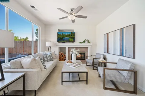 a living room with furniture a fireplace and a table