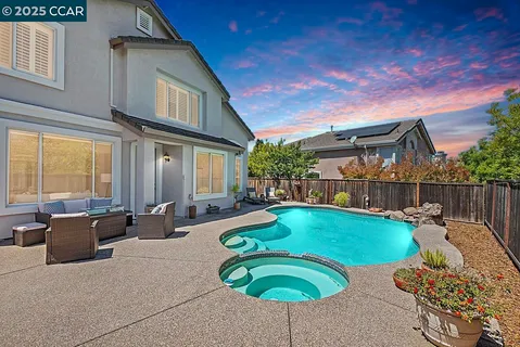 a swimming pool with outdoor seating