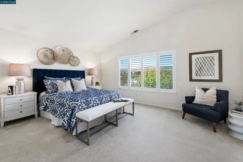 a bedroom with a bed and a couch