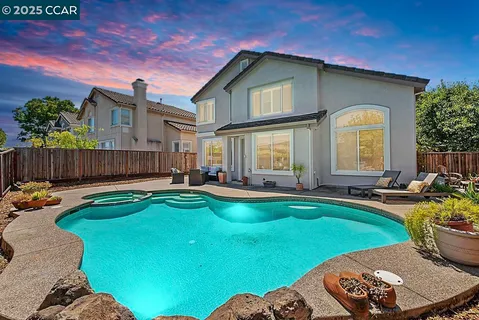 a view of a house with swimming pool and sitting area