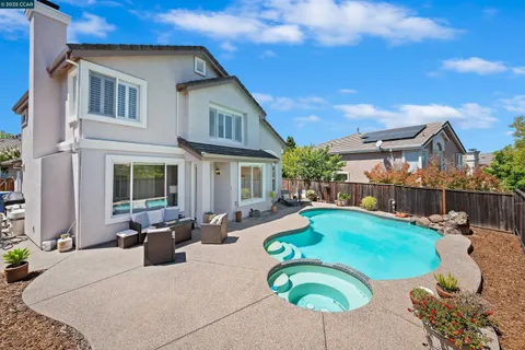 a view of a house with backyard porch and furniture