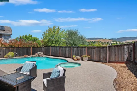 a view of backyard with seating space and trees