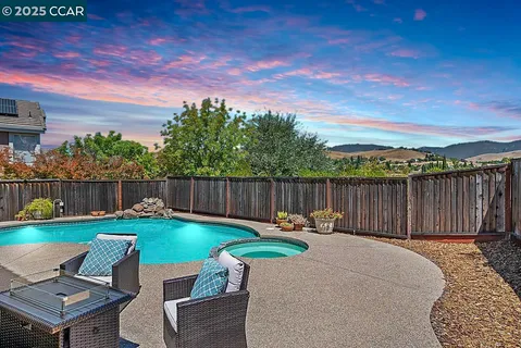 a view of a backyard with sitting area and furniture