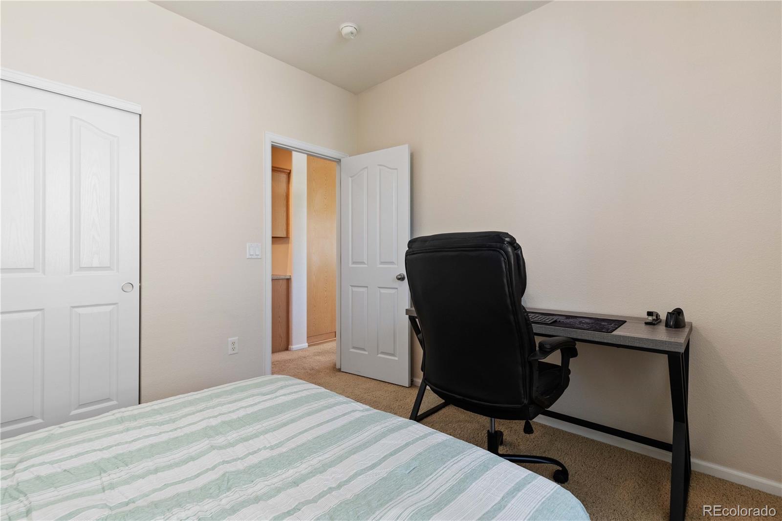 3454 Cascina Place, Unit D Highlands Ranch, CO 80126 - Photo 12 of 31 a bedroom with a chair and a window