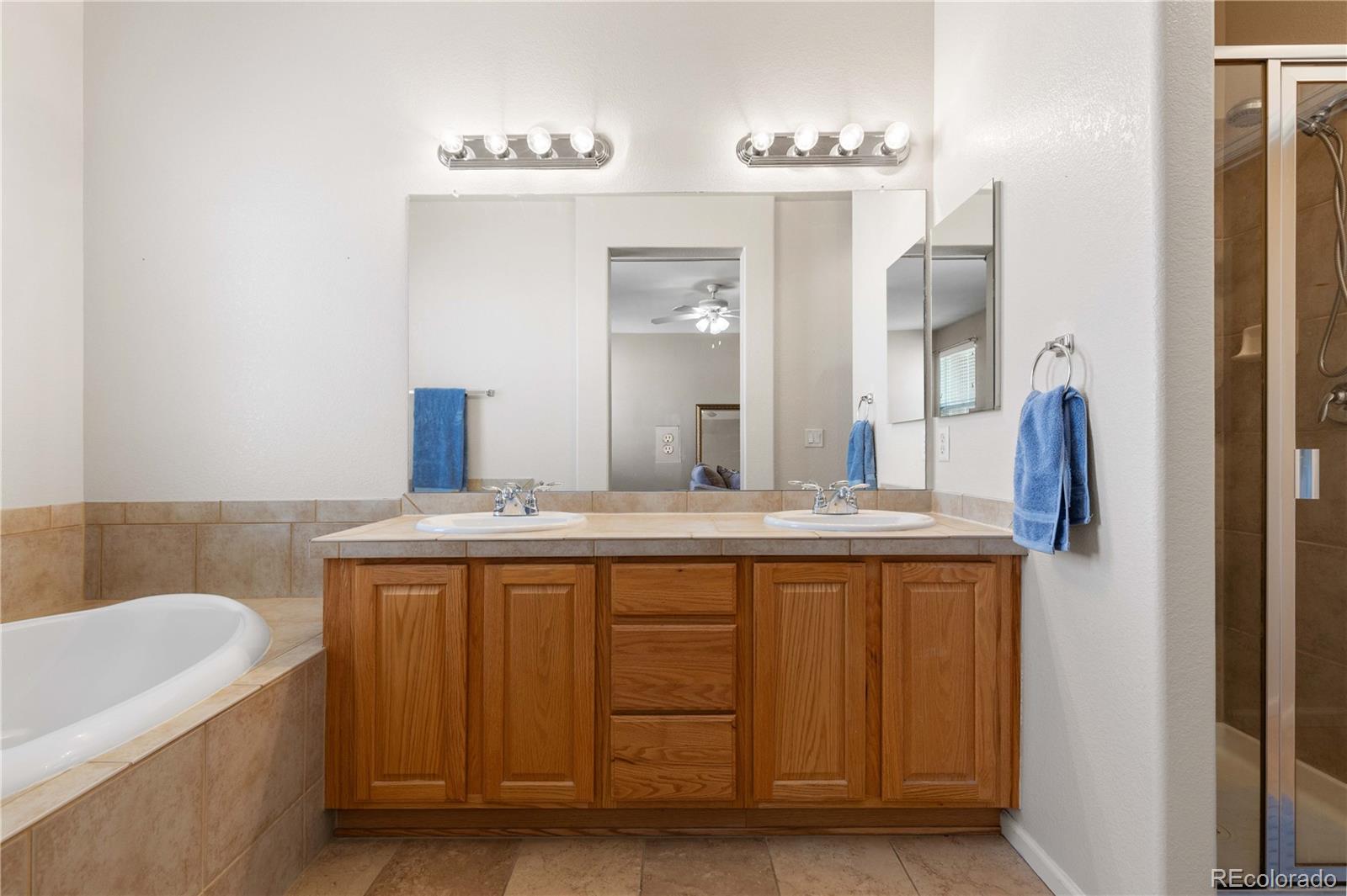 3454 Cascina Place, Unit D Highlands Ranch, CO 80126 - Photo 19 of 31 a bathroom with a granite countertop sink and a mirror