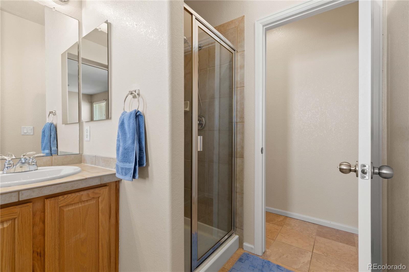 3454 Cascina Place, Unit D Highlands Ranch, CO 80126 - Photo 21 of 31 a bathroom with a shower and a sink