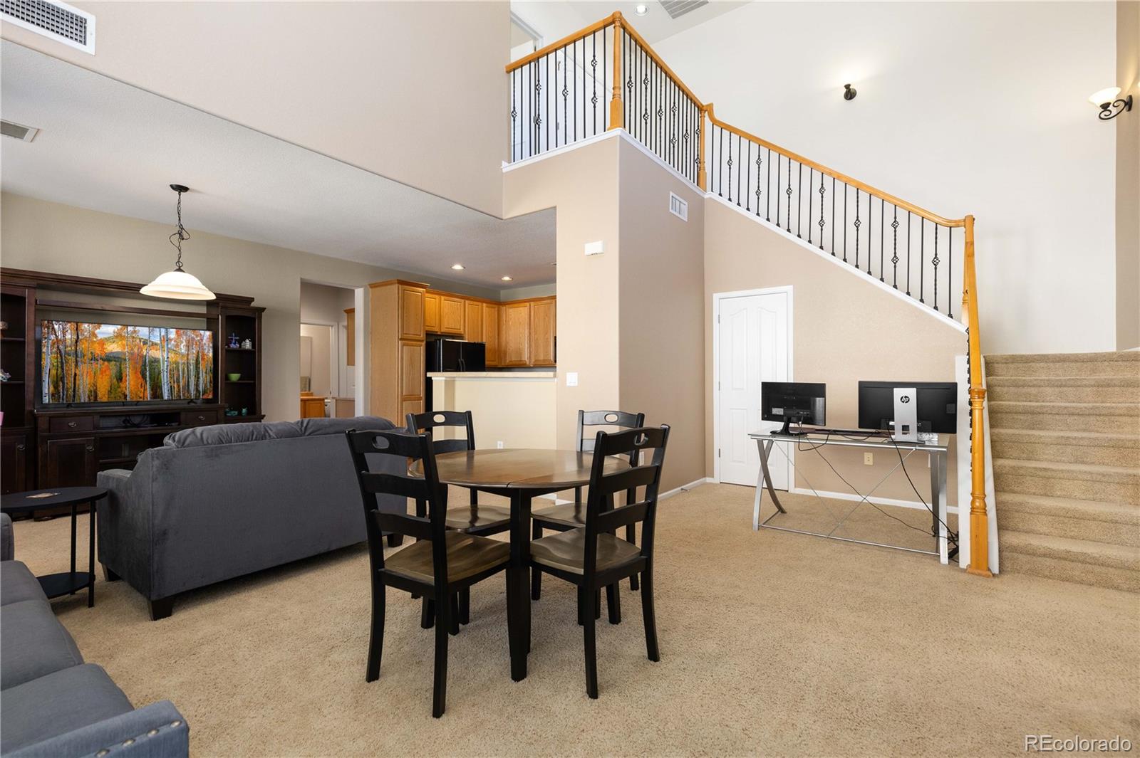 3454 Cascina Place, Unit D Highlands Ranch, CO 80126 - Photo 3 of 31 a dining room with furniture and a chandelier