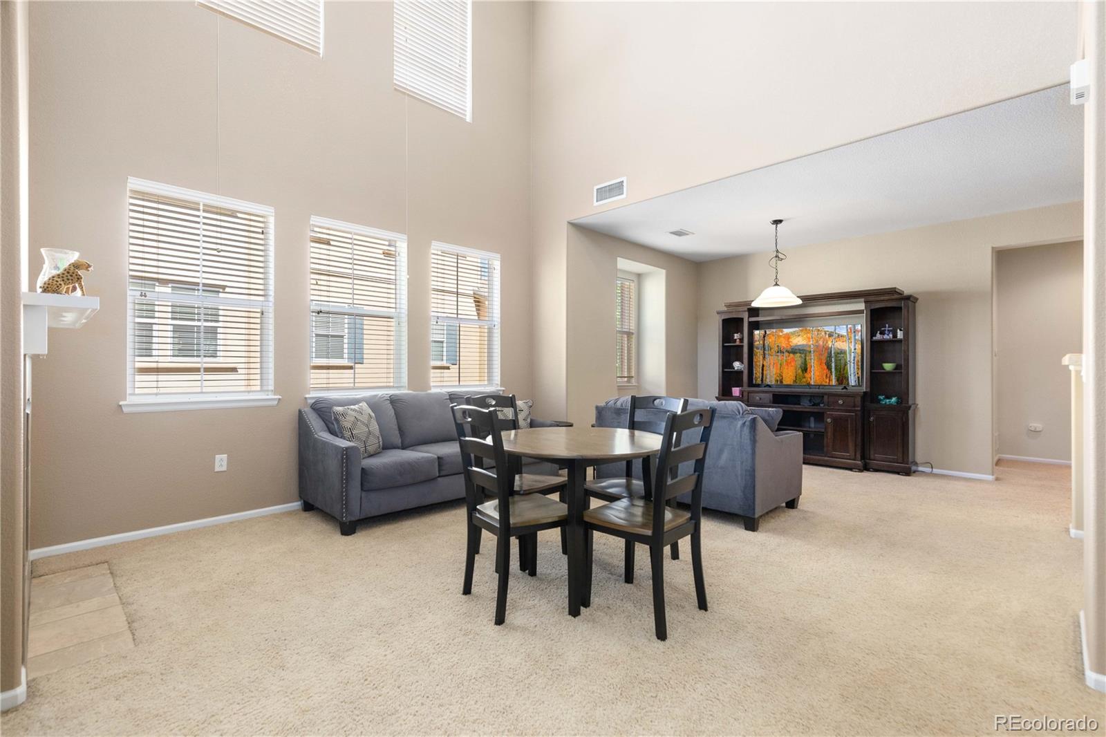 3454 Cascina Place, Unit D Highlands Ranch, CO 80126 - Photo 5 of 31 a living room with furniture and a open window