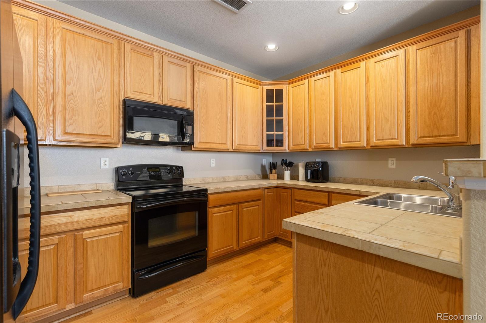 3454 Cascina Place, Unit D Highlands Ranch, CO 80126 - Photo 8 of 31 a kitchen with a sink a stove and cabinets