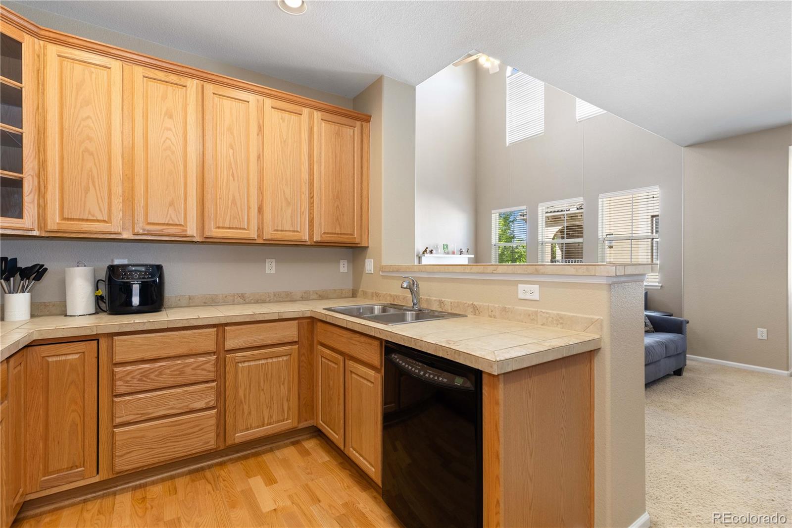 3454 Cascina Place, Unit D Highlands Ranch, CO 80126 - Photo 9 of 31 a kitchen with a sink stove and cabinets