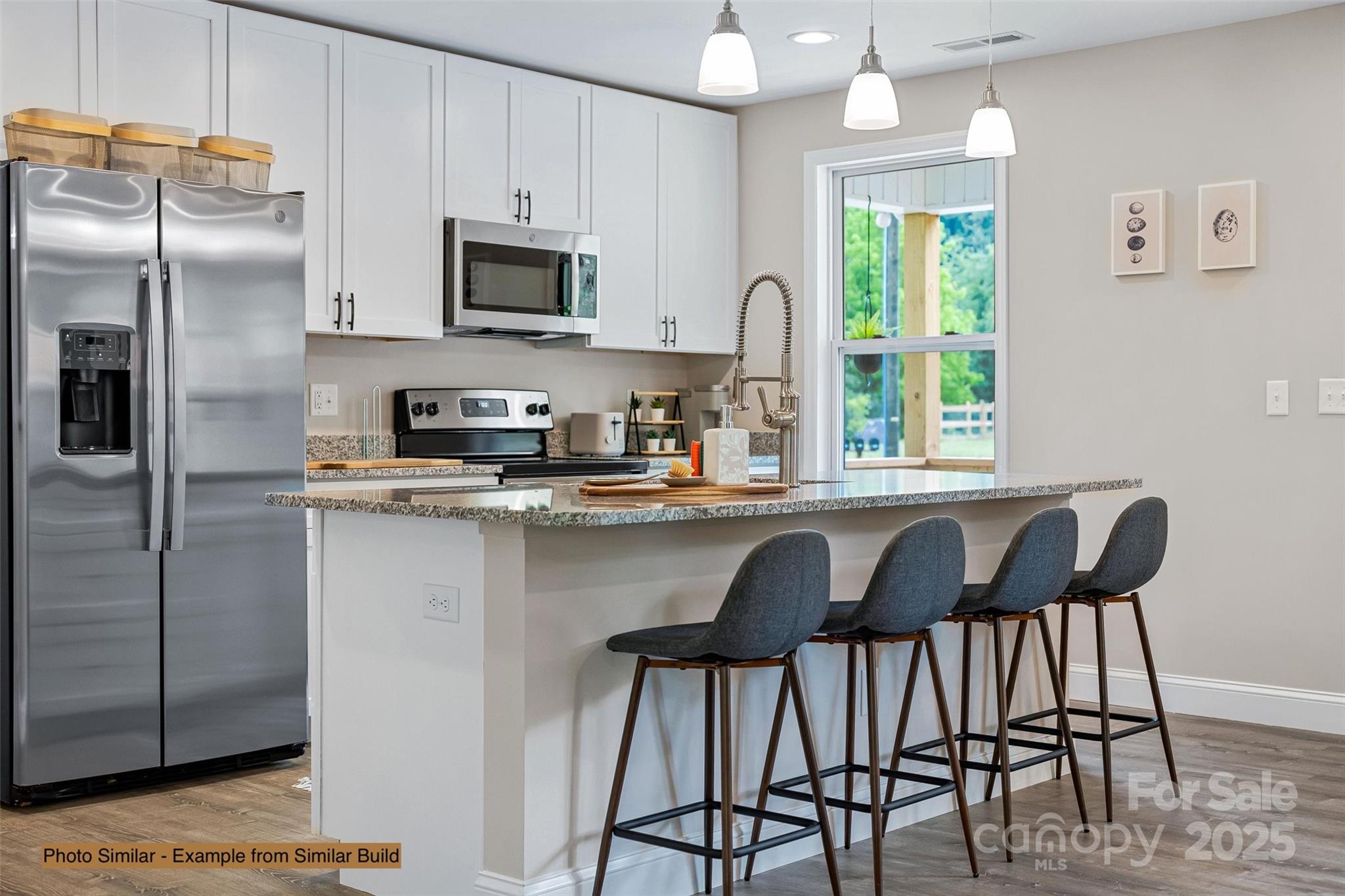 139 Burley Ridge Candler, NC 28715 - Photo 12 of 40 a kitchen with a table chairs refrigerator and microwave